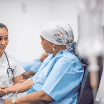 Nurse holding a patient's hands with care